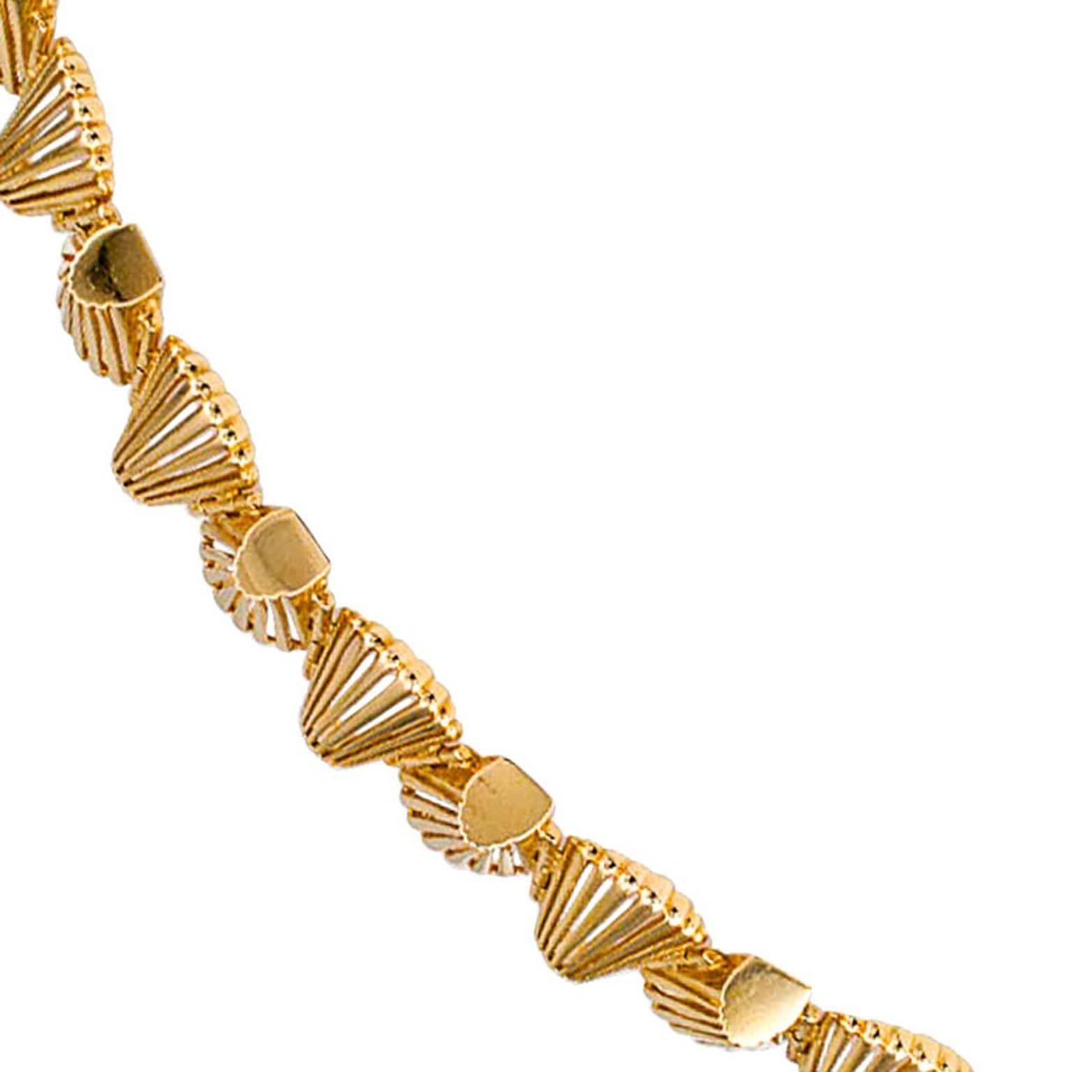 1960's Abstract Shell-Shaped Gold Link Bracelet

The design comprises a whimsical arrangement of open work, shell-shaped links that deliver a most gratifying visual effect... unconventional, different, like the woman who wears it.  Very, very easy