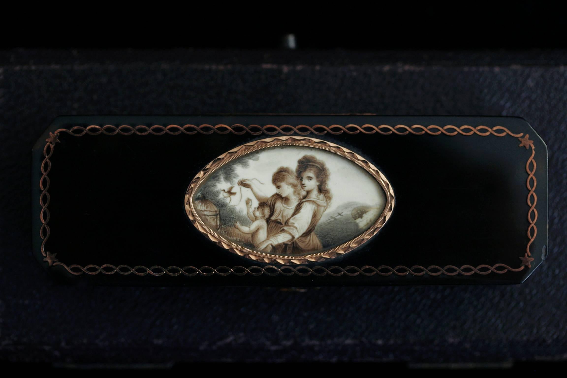 C.1780. An exquisite Georgian period faux tortoiseshell toothpick case with a very finely painted sepia miniature on the lid. The miniature painting depicts two young ladies and a child with a bird, attached to a ribbon, flying away from a cage. The