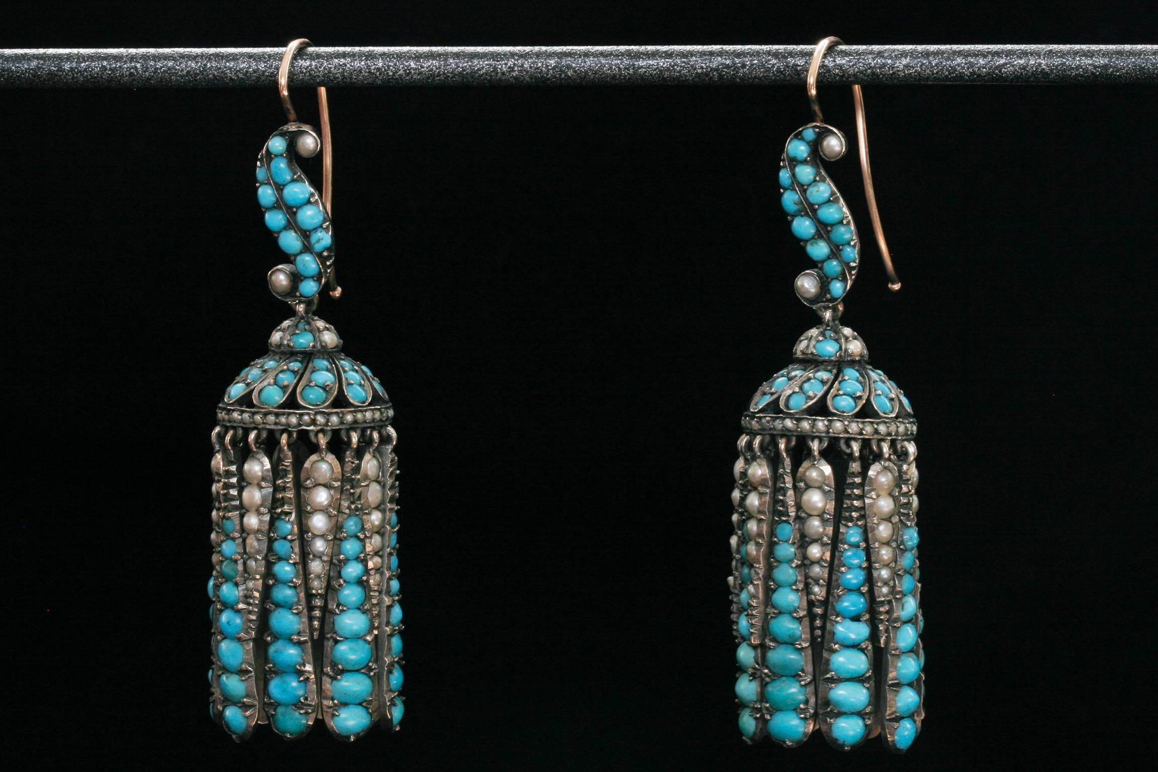 C.1860.  A spectacular pair of Victorian turquoises and pearls fringe earrings set in silver with 15k ear wires. Each dagger shape fringe drop of turquoises and pearls forms a moving pagoda. The top is accentuated with a curved S shape that is