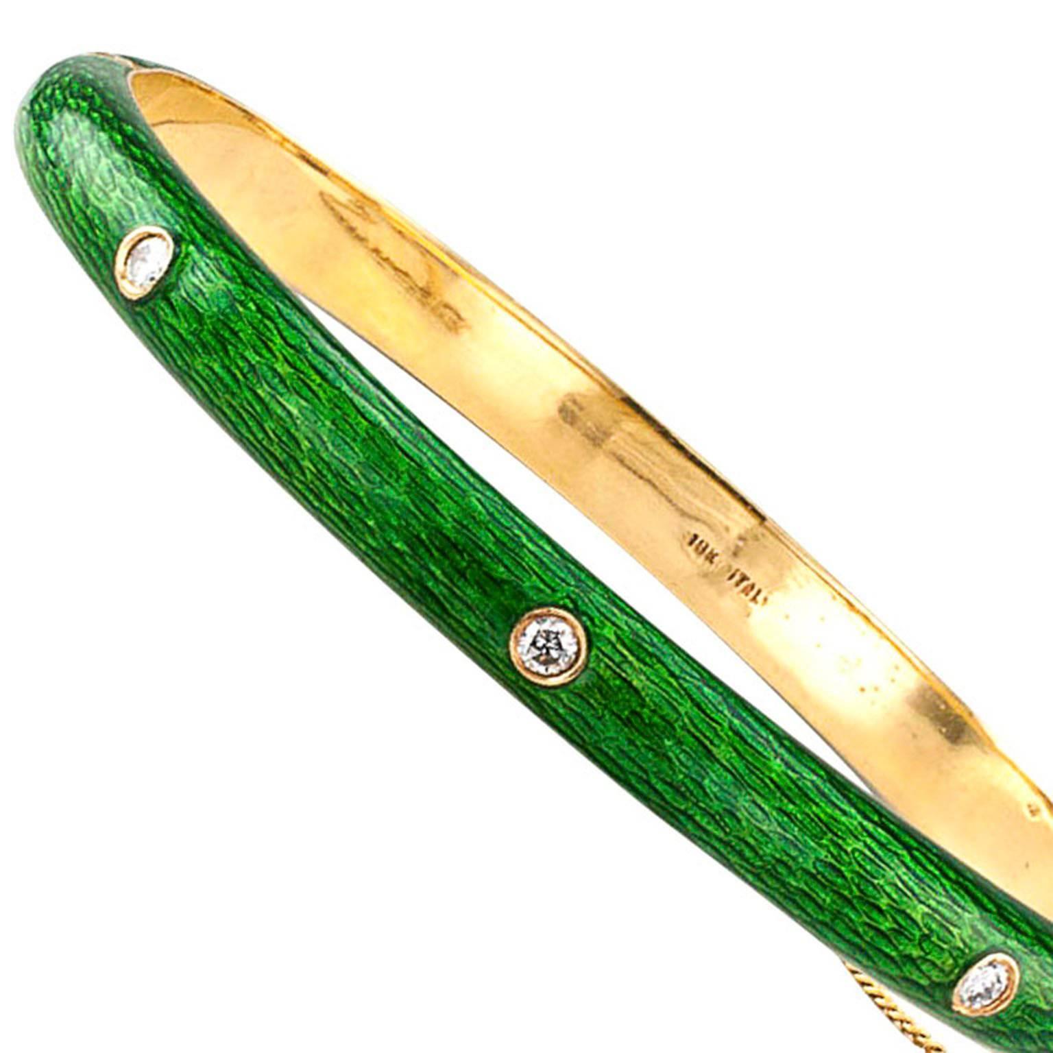 1980's Apple-Green Enamel and Diamond Bangle

Unexpected color... vibrant apple green!  The simple champleve enamel bracelet packs a wonderful punchy look, the top half studded with three bezel-set round brilliant-cut diamonds to lend a starry