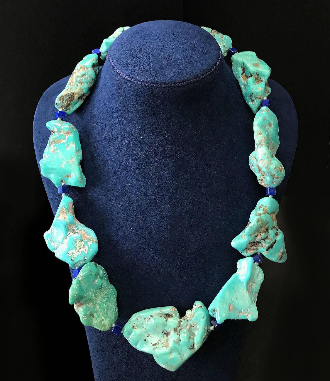 This one of a kind necklace features 11 large Turquoise nuggets and lapis lazuli cube links with ring and toggle clasp in 18kt yellow gold.
