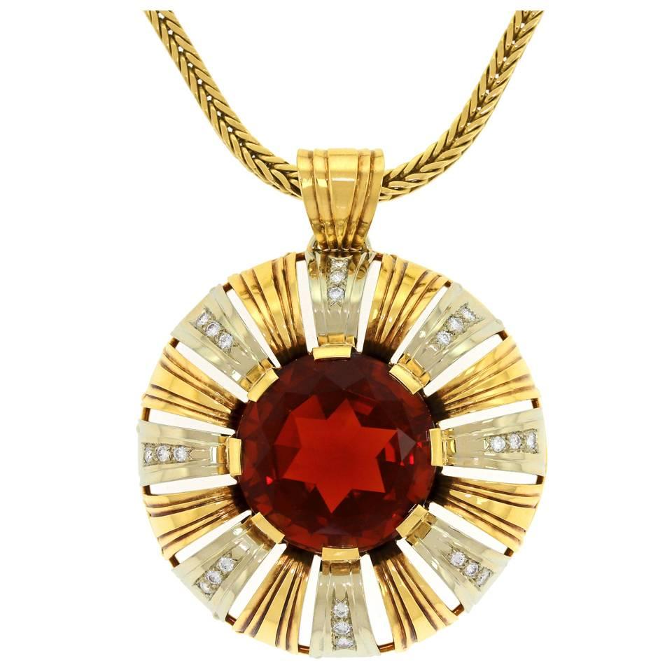 Circa 1970s, 18k, Kurz, Swiss, Zurich.  This very seventies fashion pendant is set with a huge 30 carat Madeira citrine and .48 carats of brilliant white diamonds. The sunburst motif is stylishly post-modern, effortlessly chic, and brilliantly