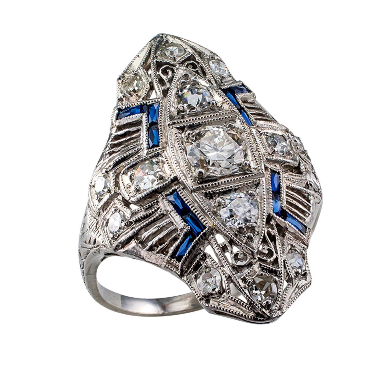 Art Deco platinum and diamond dinner ring

Genuine Art Deco platinum and diamond dinner ring set with fifteen round diamonds totaling approximately 0.85 carat, approximately H - K color and VS - SI clarity, circa 1925.  With its trio larger