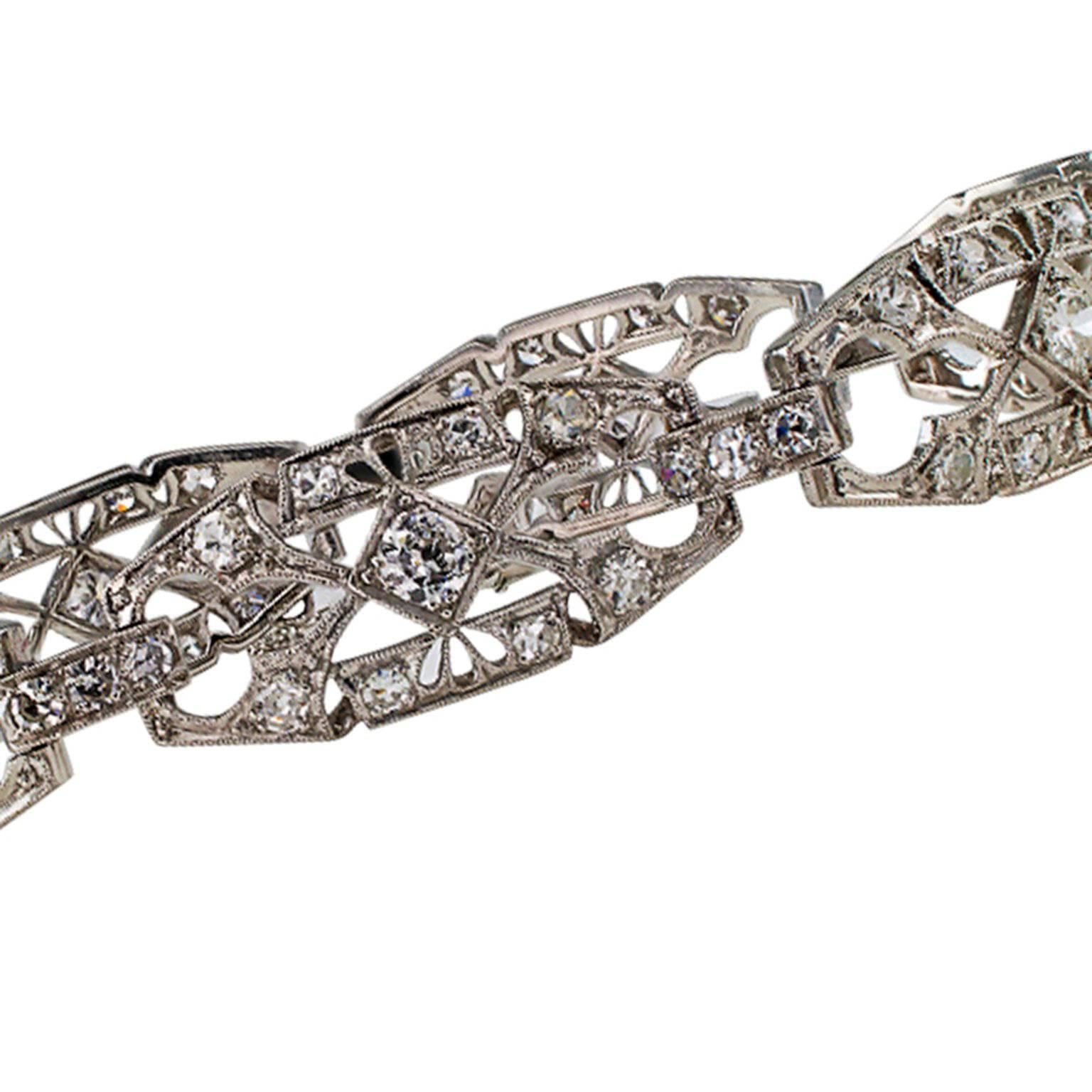 1930s Art Deco Diamond and Platinum Bracelet

1930's Art Deco 2.75 carats diamond bracelet mounted in platinum.  This Art Deco design is characterized by an airy and lace-like appearance provided by the open work links decorated with millegrain,