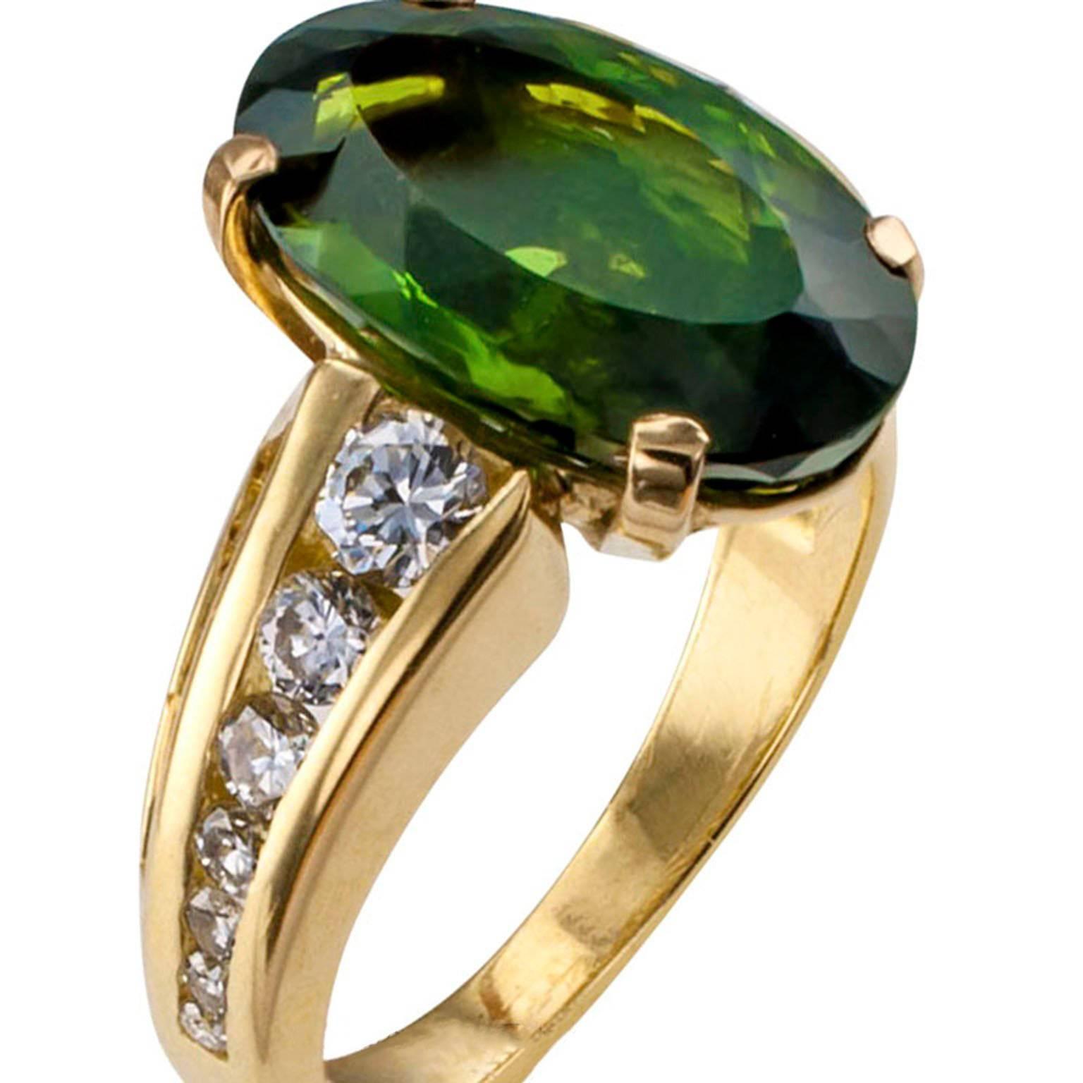 Green Tourmaline Diamond Gold Ring

1980s green oval tourmaline ring round and baguette diamonds mounted in 18 karat yellow gold.  Possessing a deep and satisfying color and weighing approximately 6.75 carats, the large green tourmaline set
