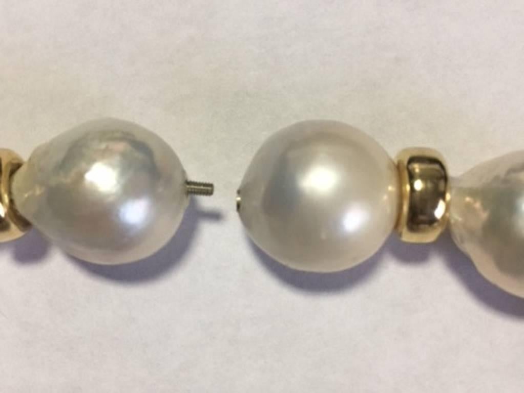 A wonderful high luster Cream White cultured natural water slightly baroque large pearl necklace slightly graduated 18mm to 15mm most pearls on the larger size attached to a 14karat gold invisible clasp. The necklace is 18 inches long.