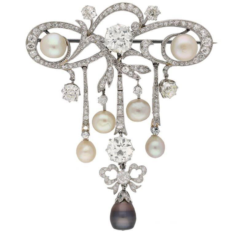 Edwardian natural pearl and diamond pendant/brooch, circa 1905.  For Sale