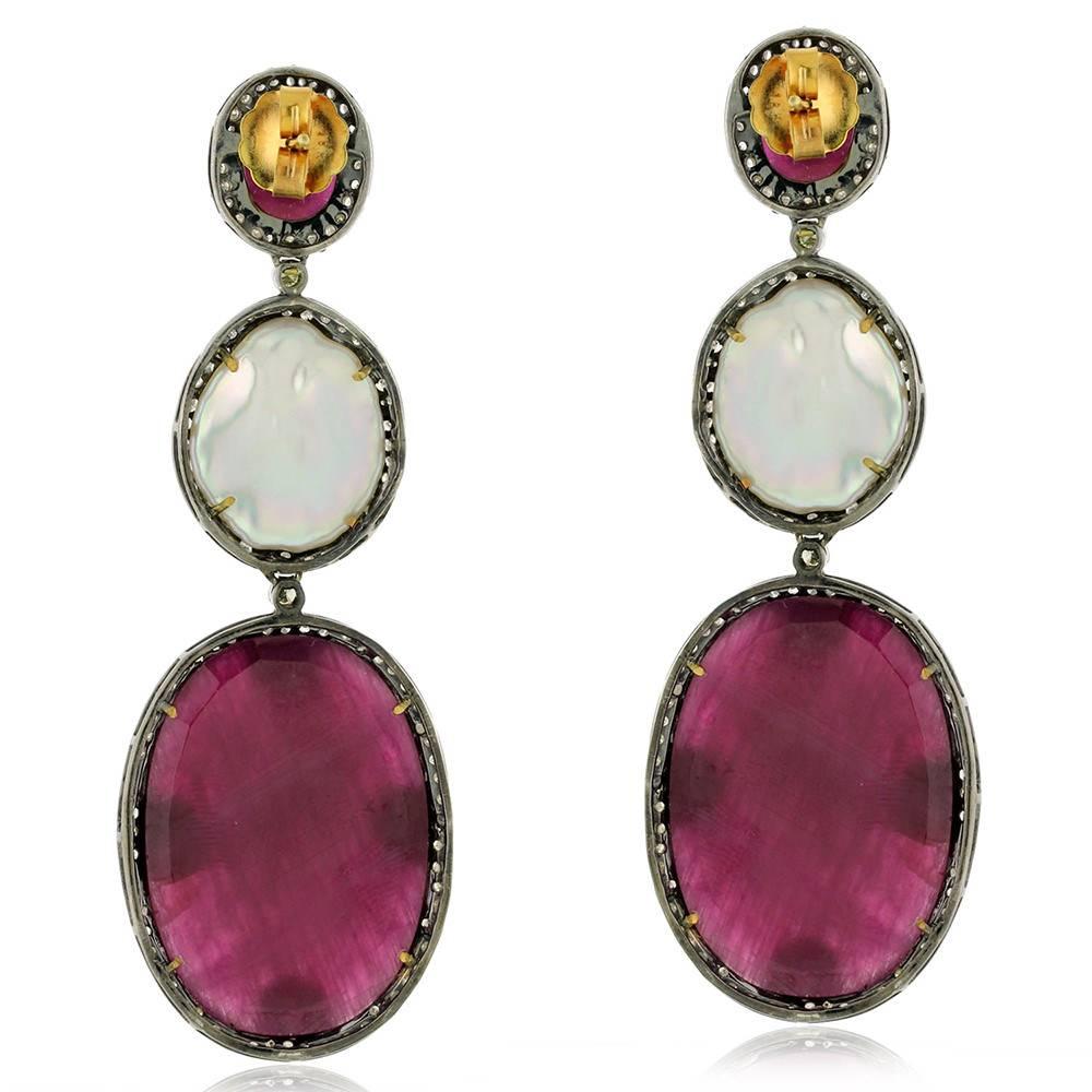 This 3 tier slice treated ruby and pearl earring is a gorgeous earring to wear for any cocktail and get many compliments. 

18k:2.52g
Diamond: 4.19cts
Slv:12.56gms
Treated Ruby: 74.25cts
Pearl-12.75cts
