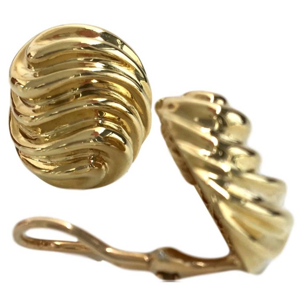 Vintage 1970's 18k yellow gold earrings by Van Cleef and Arpels. The ear clips,  featured in the 1978 Van Cleef and Arpels Boutique collection are just under 1" x 3/4" and made in a stylized wave design. Flattering and an easy to wear