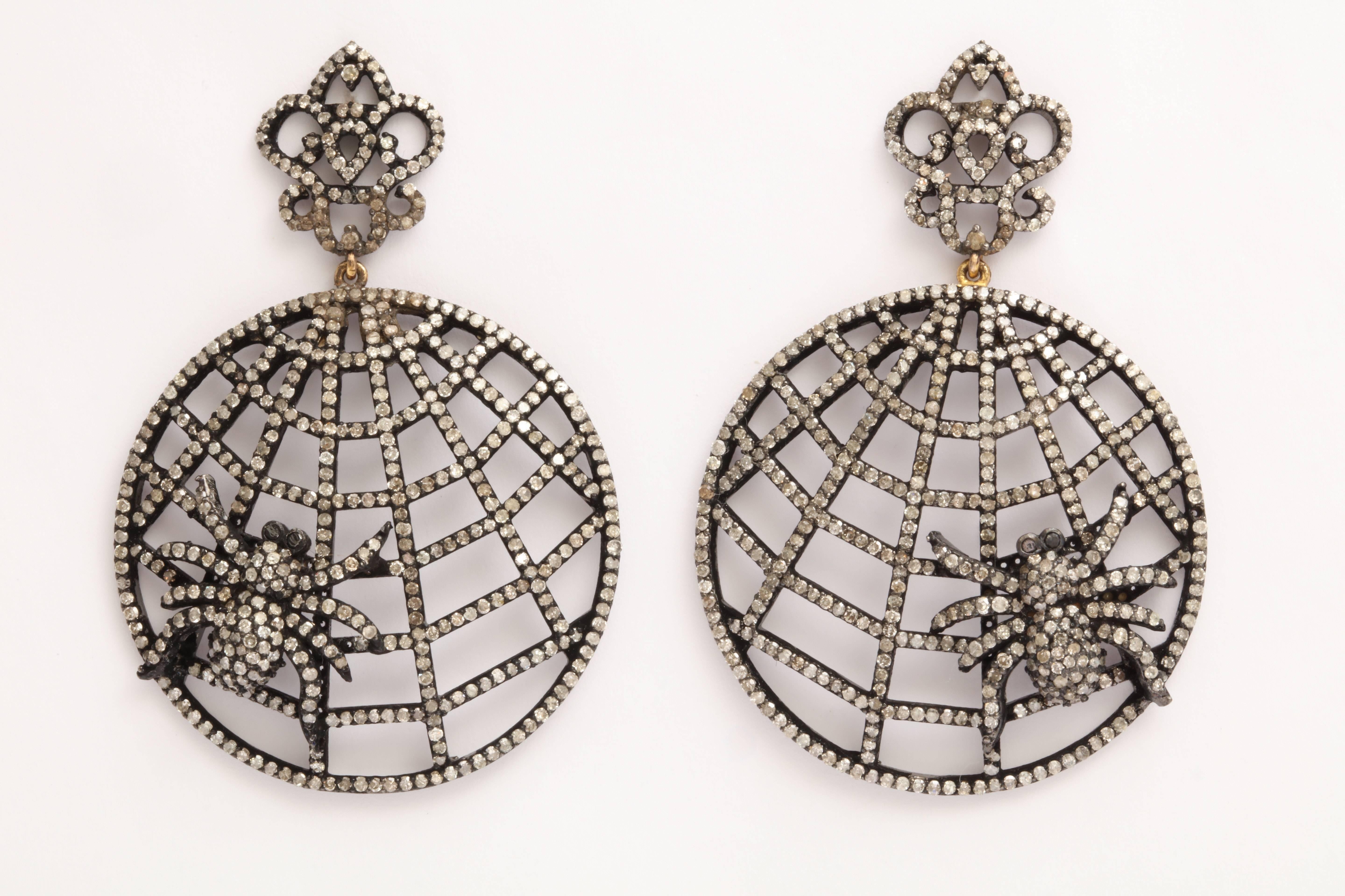 A pair of rhodium plated sterling silver and diamond spider web earrings. The webs are suspended from rhodium plated sterling silver and diamonds crowns.
There are approximately 5.45cts of diamonds.
Length: 2.20 inches
Width: 1.50 inches
Spider