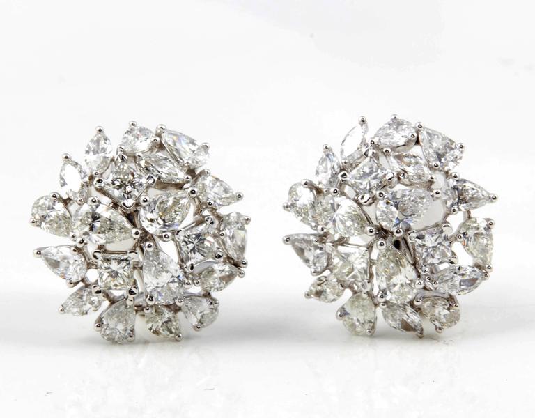

A unique pair of earrings featuring multi shape diamonds set in a slightly dome button design. 

6.12 carats of F/G VS pear, marquise and princess cut diamonds set in 18k white gold.

Approximately .75 inches in diameter. 

Please contact us for