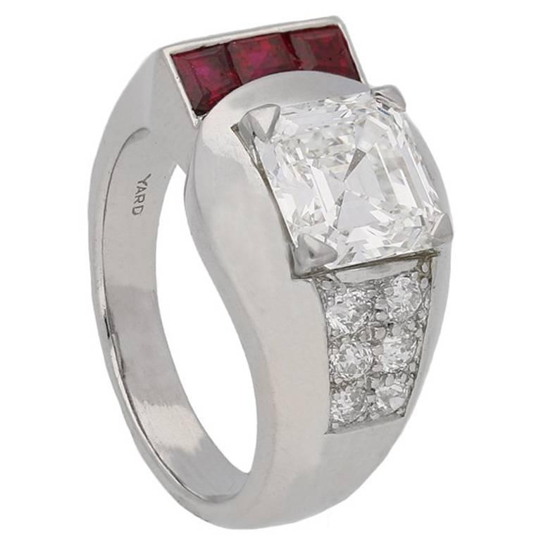 Yard Inc. diamond and ruby ring. Set centrally with one octagonal asscher cut diamond, F colour, VS2 clarity, with a weight of 1.87 carats in an open back claw setting, with a recessed vertical row of three tapered baguette cut natural unenhanced