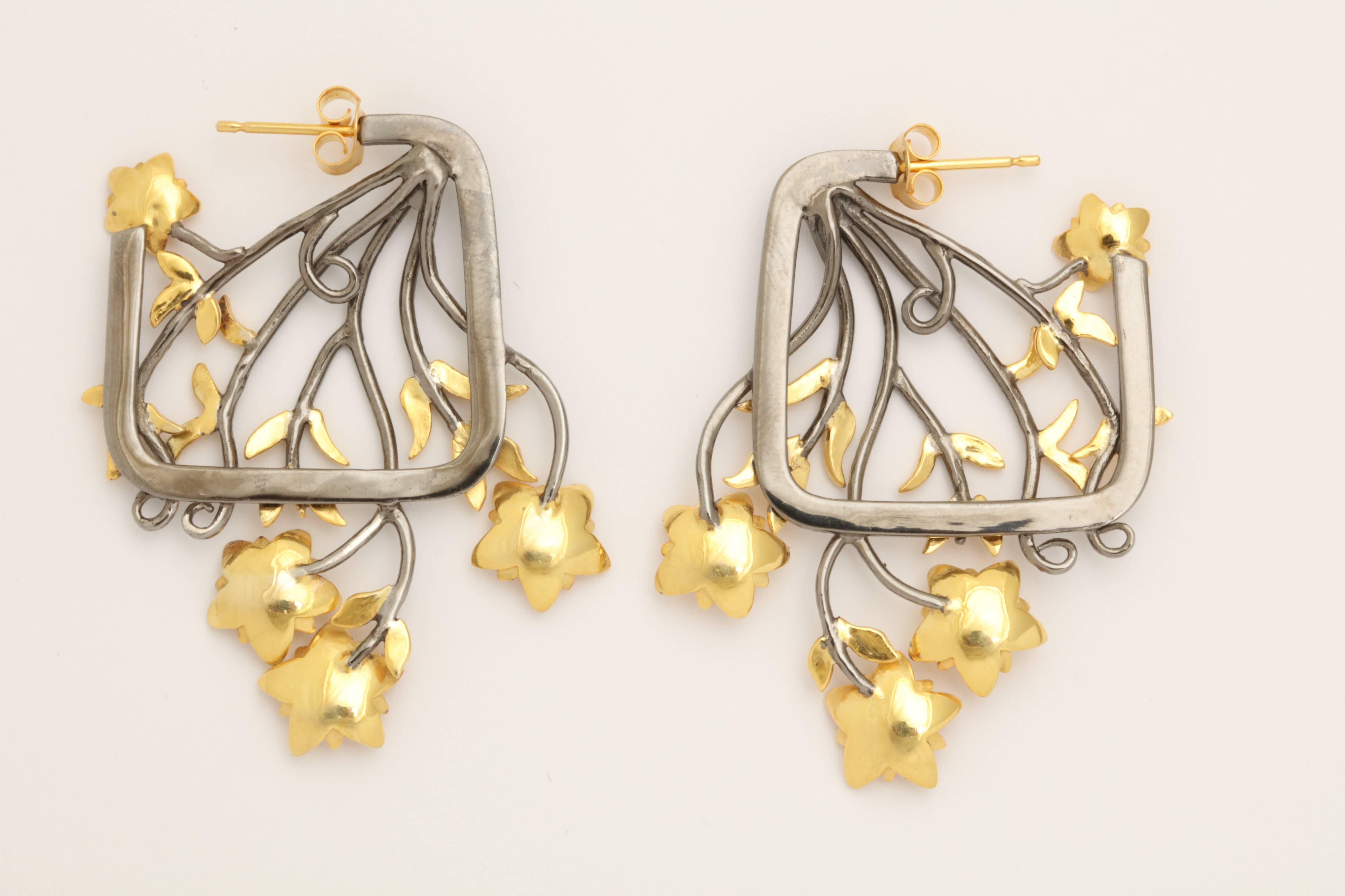 A pair of 18kt yellow gold and rhodium plated sterling silver tulip boquet earrings. The earrings are composed of an 18kt yellow gold brick wall background and a rhodium plated sterling silver tulip boquet overlay.   

     Length: 1.50 inches 
 