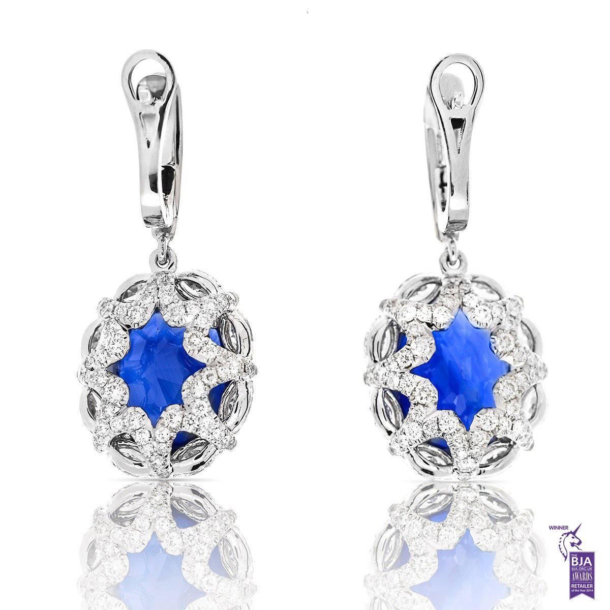 NATURAL SRI-LANKA SAPPHIRE DROP EARRINGS - 28.31 CT

Set in 18Kt White gold


Total sapphire weight: 24.70 ct
[ 2 stones ]
Color: Blue
Origin: Sri Lanka

Total marquise cut diamond weight: 2.45 ct
[ 16 diamonds ]
Color: G-H
Clarity: VS

Total round