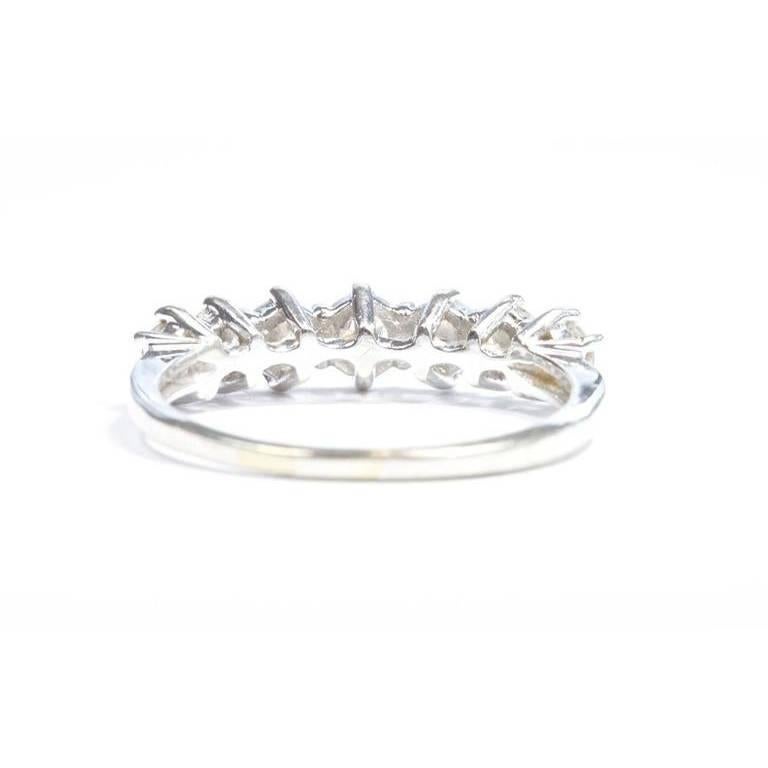 The diamonds are lively in this refined elegant band ring. Designed with 7 diamonds and crafted in 14k white gold. 

Size 8 and can be re-sized.