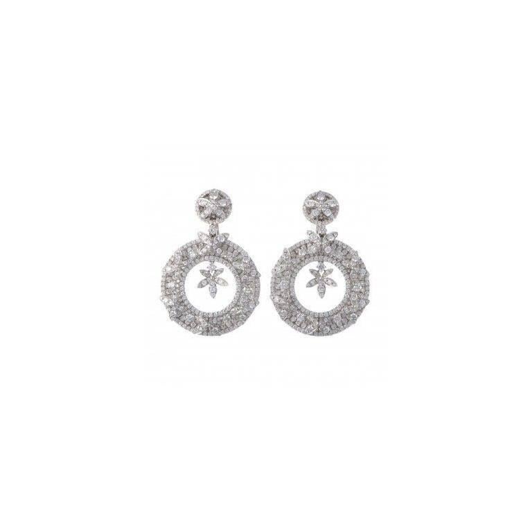 Fine quality diamond drop earrings, circular hoop design with floral motif, containing 13.60 carats of round full-cut diamonds. Diamond quality graded as VS2 clarity, H color approx.  Hallmarked: 750, Odelia.
Earrings measure 2 inches long, 1.4