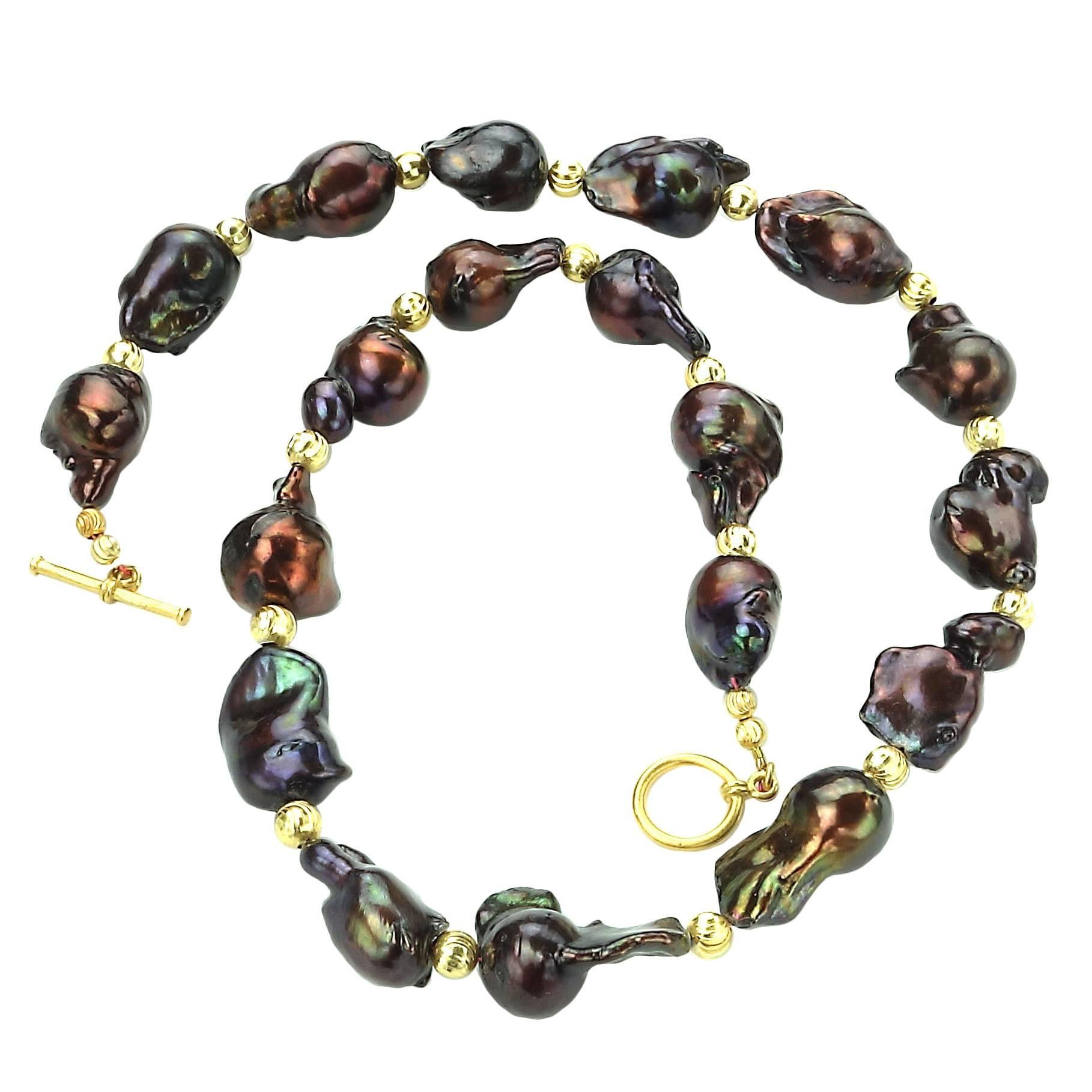 Baroque Pearl Necklace in wonderful shades of iridescent deep wine/brown with flashes of green and pinky-red. These funky, freeform Pearls are a joy to wear.  Etched gold tone spacers accent them and they are secured with a gold tone toggle.  The