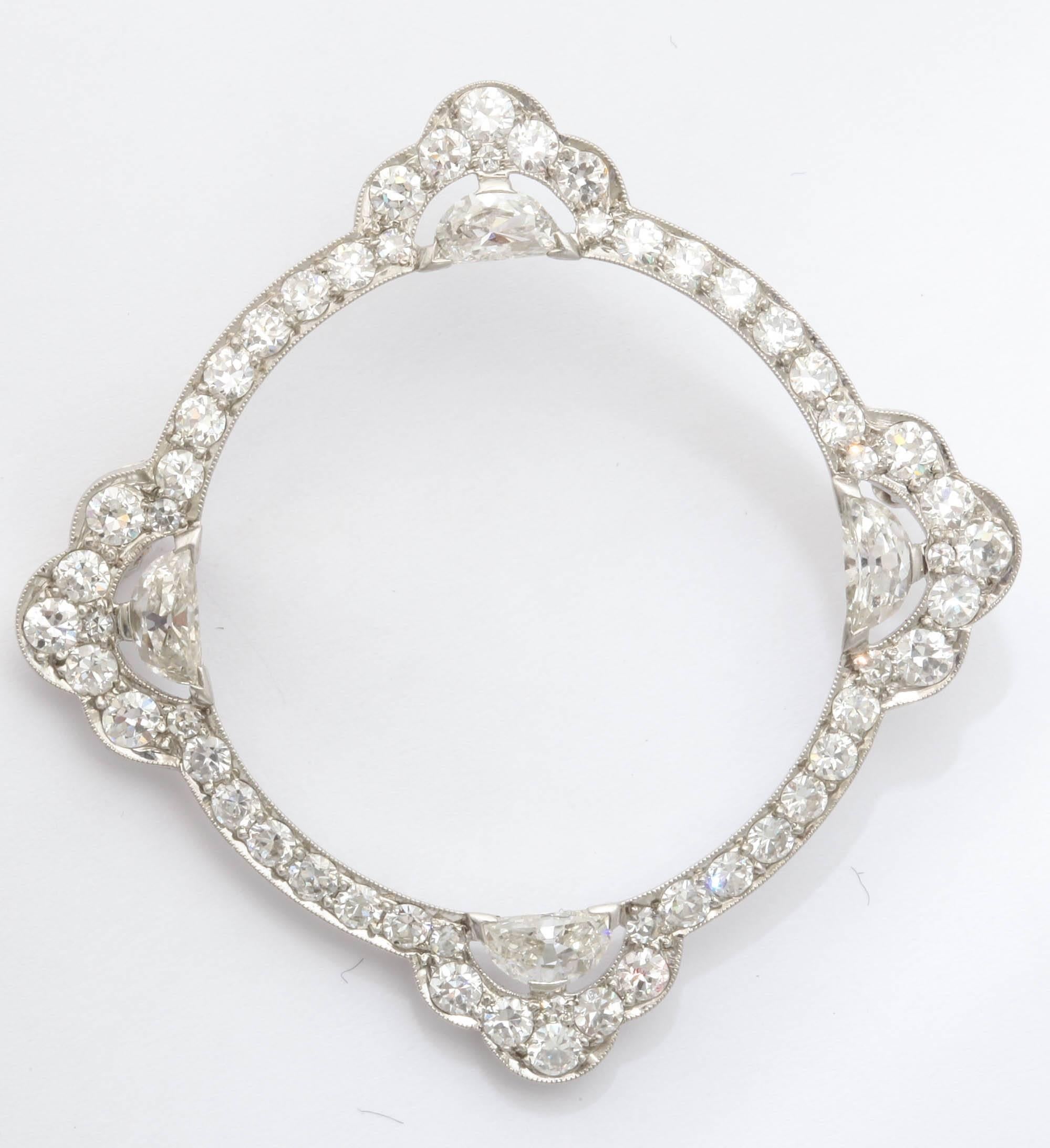 This platinum circle brooch from the 1920s is set with four half moon-cut diamonds at intervals, forty-four round diamonds and twelve single-cut diamonds. Of excellent platinum workmanship set with high-quality diamonds. 

Circa 1925.

1 7/8 in.