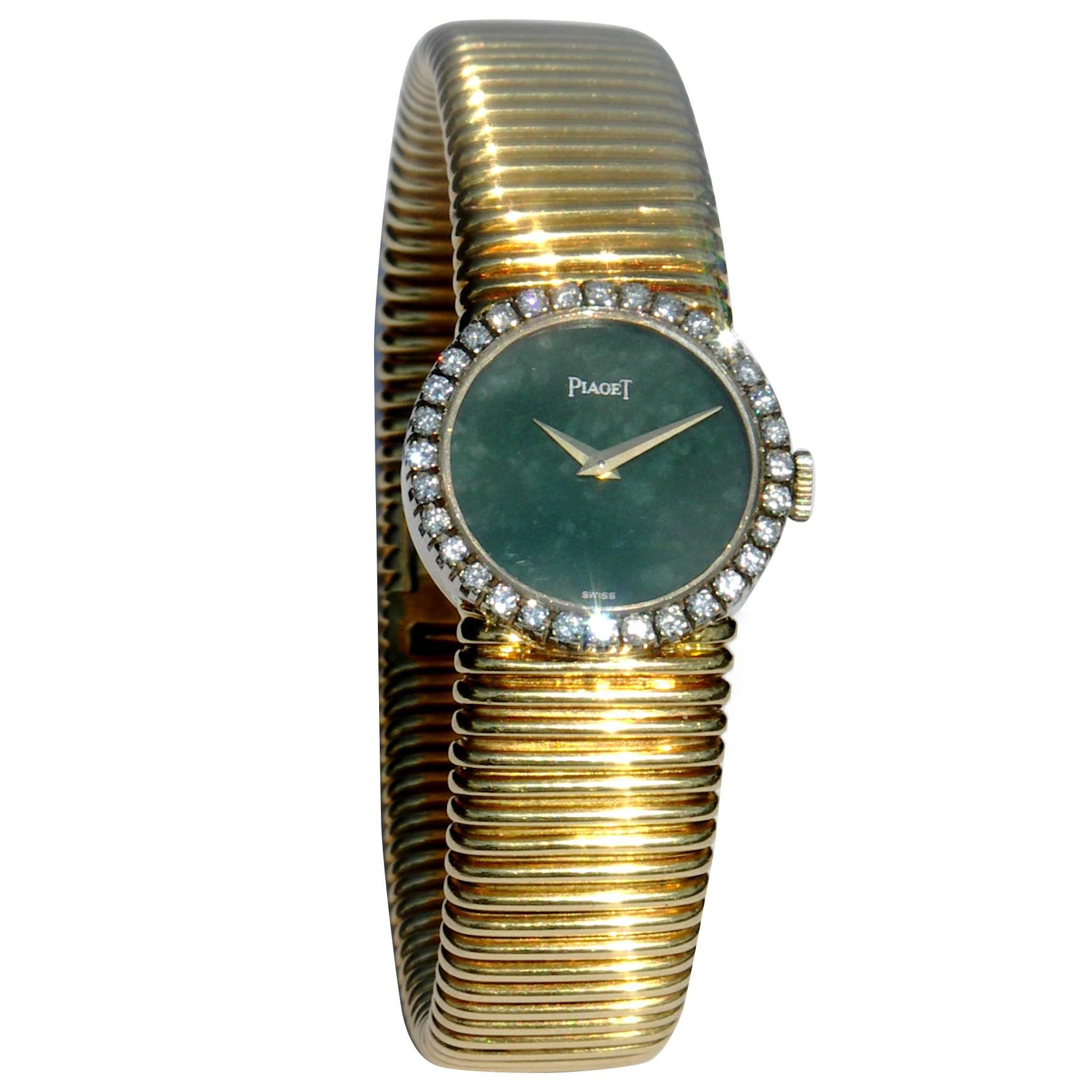 Ladies 18K yellow gold Piaget wristwatch, featuring a "Tubo Gas" style bracelet. Set with a total of approximately 1ct of round brilliant cut diamonds, and jade dial. Bracelet measures 6 7/8 inches.