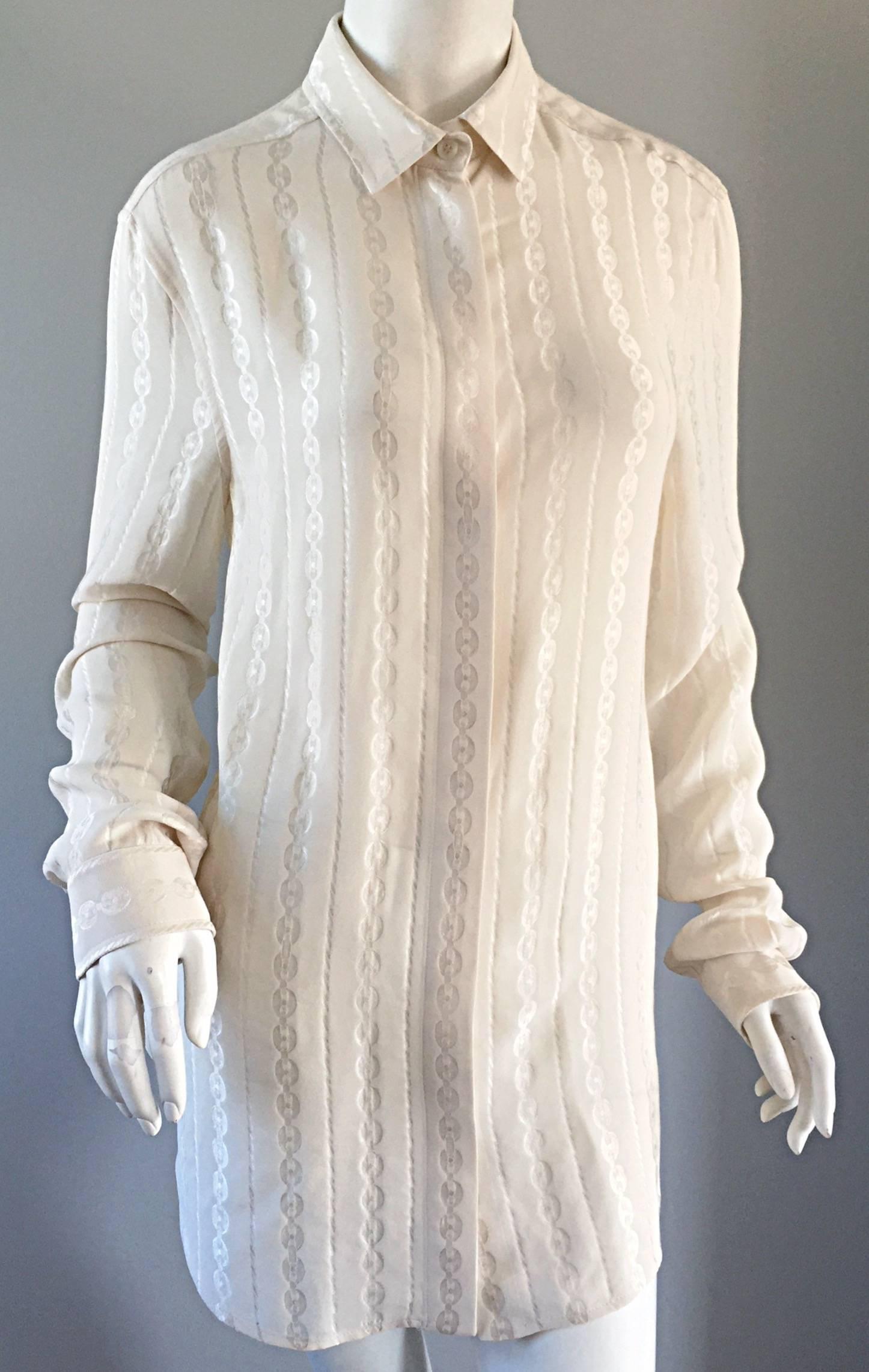 Gorgeous vintage Gucci, by Tom Ford, ivory silk long sleeve blouse. Chain / horsebit print throughout. Buttons up the bodice, with buttons at each cuff. Can easily be dressed up or down. Great with jeans, a skirt, trousers, or under a suit. In