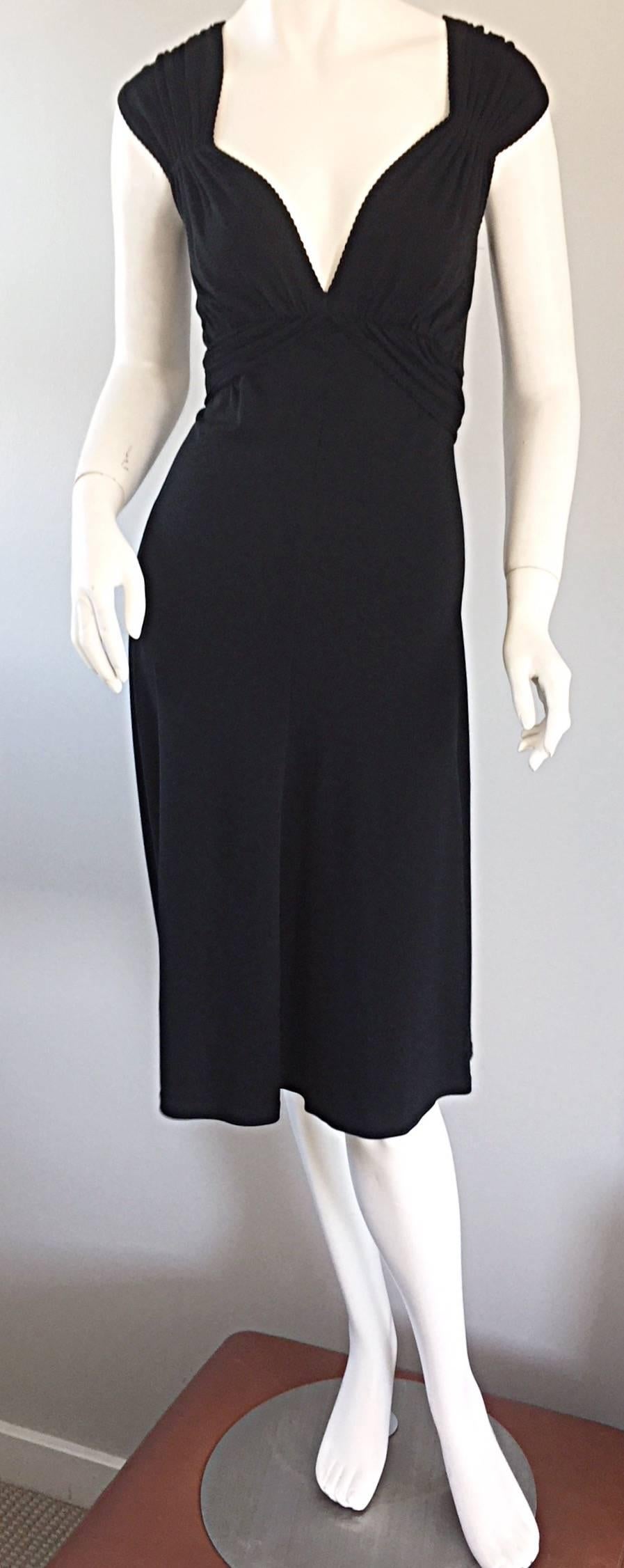 Beautiful, and extremely flattering Michael Kors Collection signature jersey dress! Flattering bust, with cute cap sleeves. Attached tie belt can be tied in the front or back. Signature MK jersey, that hugs the body in all the right places, and