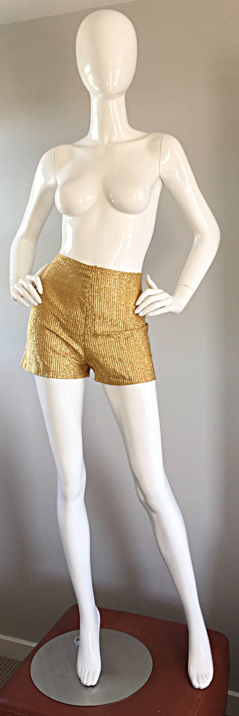 Incredible, and rare vintage 70s HENRY HIGGINS three piece ensemble! Gold and blue metallic dress, with vibrant oriental theme, along with clear rhinestone buttons up the bodice. Seperate hot pants (mini shorts) in gold metallic, with hidden zipper