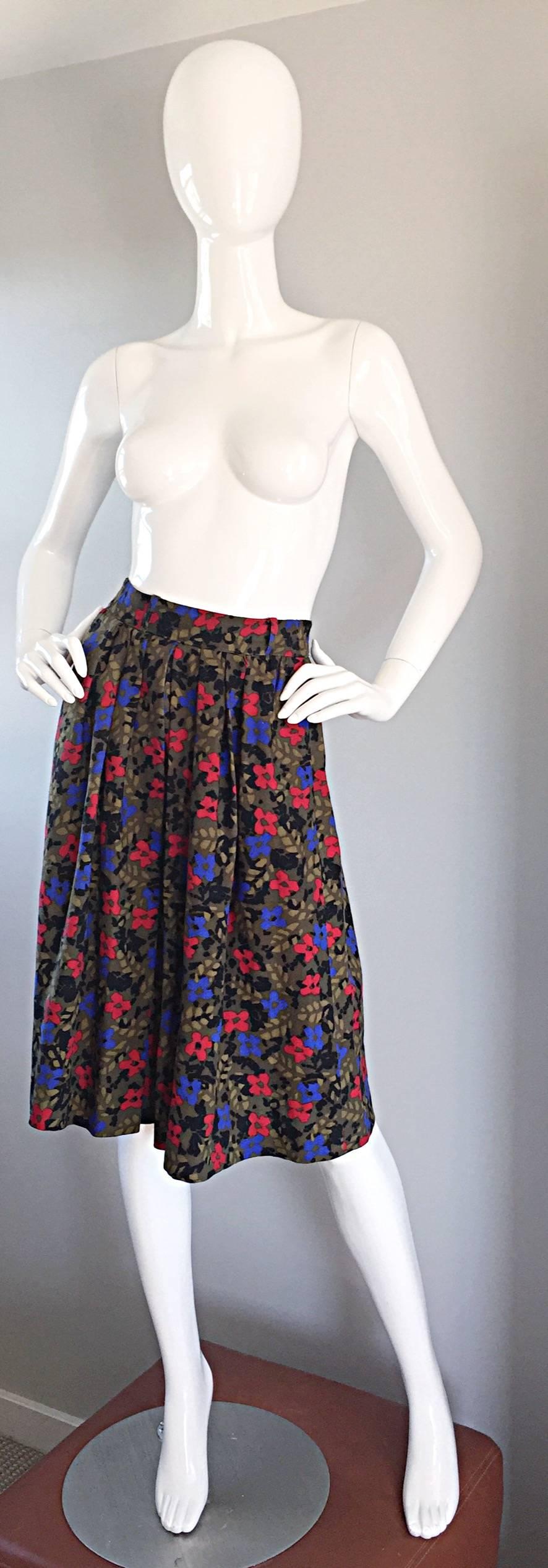 Adorable vintage Guy Laroche wool pleated skirt! Wonderful hues of olive greens, with red and blue flowers throughout. Buttons up the back. Can easily go from day to night. Perfect with a blouse, yet great with a casual tank, or turtleneck. Pairs