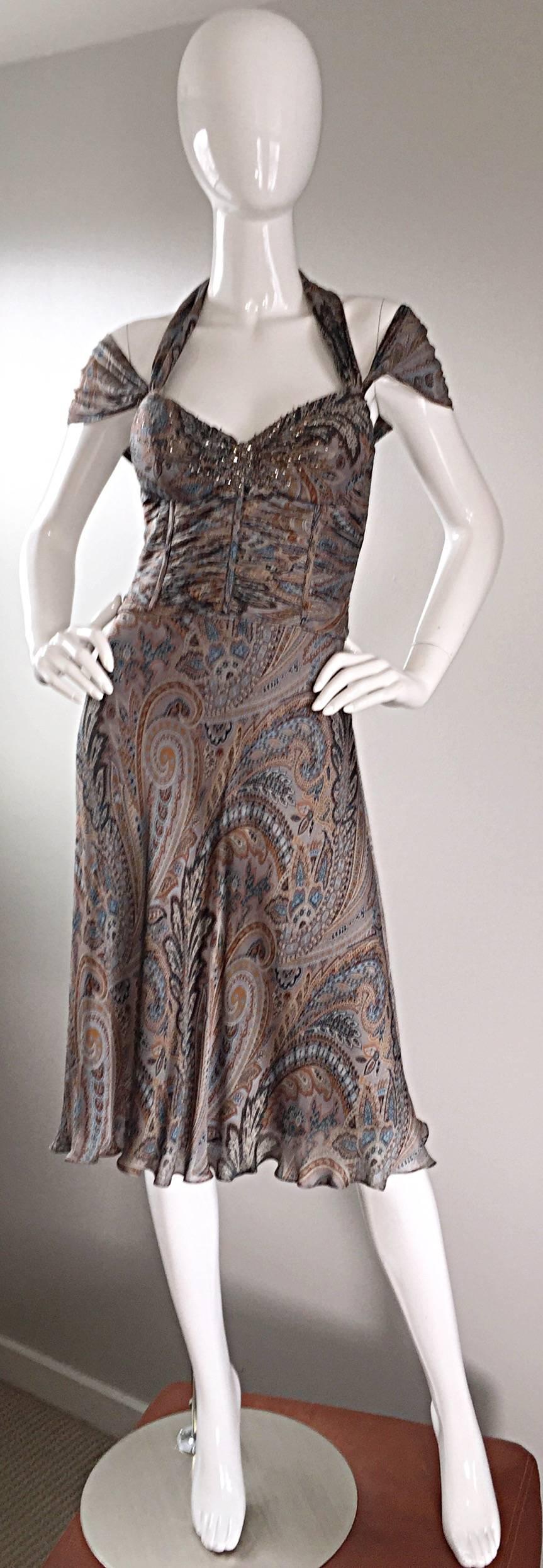 Absolutely stunning early 200s Badgley Mischka silk dress! Features beautiful neutral tones of blues, grays, and tan! Paisley print, with dozens of beads encrusted at the bust. Pleating detail at bust, which is boned. Halter neck, with cap sleeves,