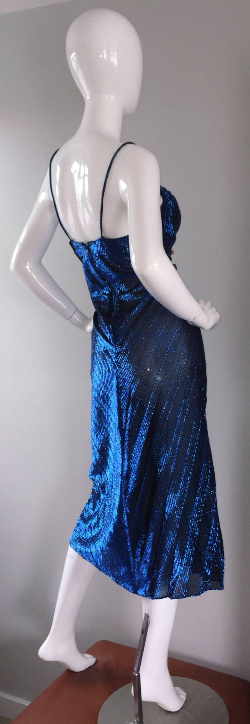 Sexiest vintage Samir 1970s disco dress! Blue metallic color, with intricate pleating throughout the front. Mock buttons down the bodice. Spaghetti straps, with a feminine bust line. Looks great on, and can be worn with, or without stockings.
