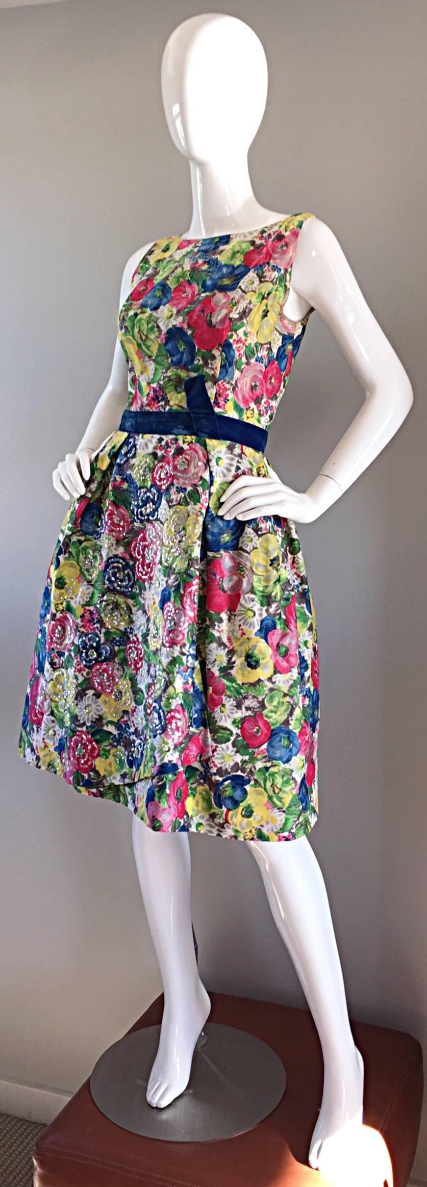 This is one of my favorite 1950s dresses EVER!!! Demi Couture, with hand sewn finishings, and hand-sewn sequins. Divine silk, with an exceptional floral watercolor print. Sequins adorned on the front petal of the skirt. Attached crinoline under