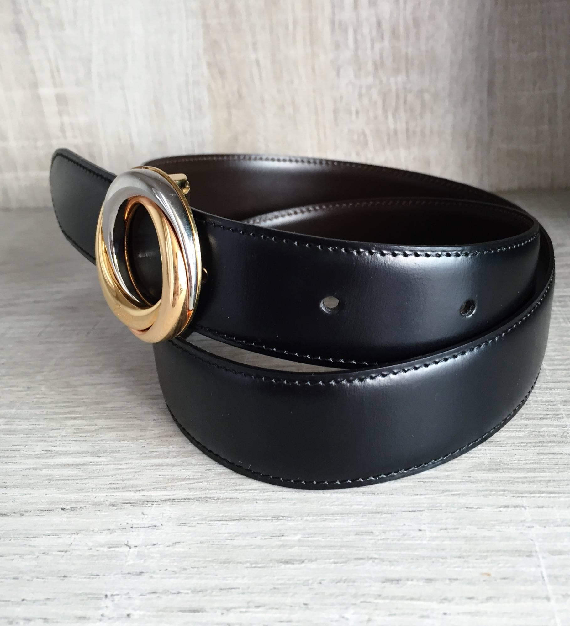 Amazing brand new Cartier belt! Reversible, with brown on one side, and black on the other. Signed Cartier buckle, with two-tone silver and gold. Signed on the front and back of the buckle, and on the leather belt. Can be worn by both a man, or