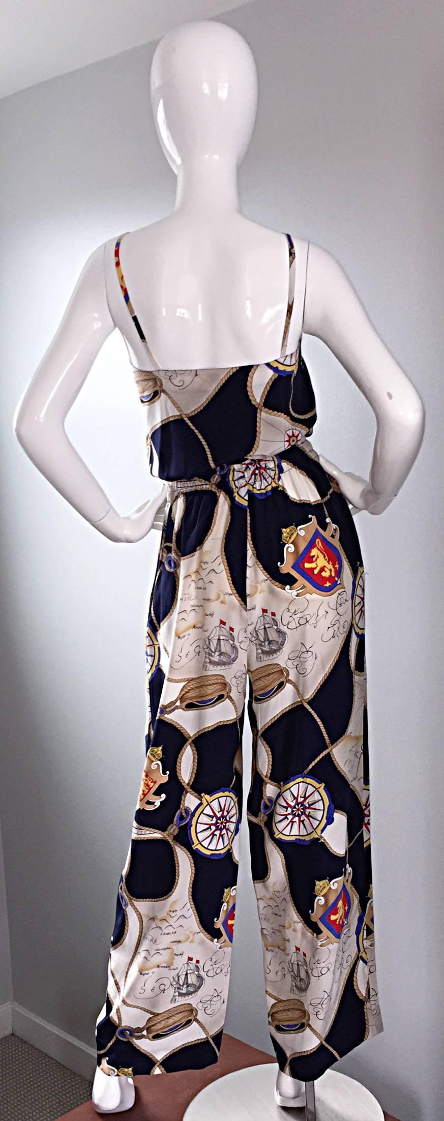 Important, and extremely rare late 1970s, early 1980s Gucci nautical pant set! Features silk sleeveless blouse, and drawstring wide leg trousers. Navy and ivory backdrop, with chic maps, compasses, boats, and anchor prints throughout. So utterly