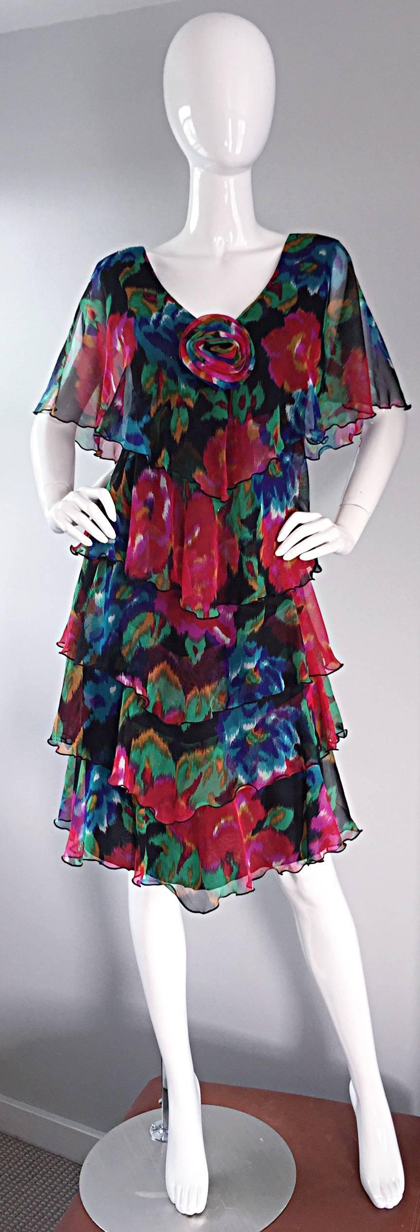 
Absolutely beautiful vintage Holly's Harp chiffon watercolor floral Boho dress. Features multiple tiers of fabric down the front and back, with a caplet like bodice, adorned with a matching rosette at bust. Signature Holly's Harp silhouette, that