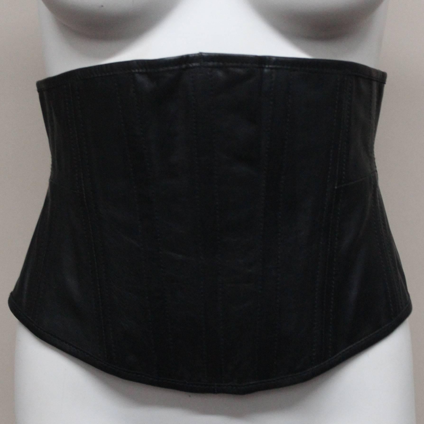 This waist cincher is pure Vivienne Westwood, a lifelong champion of corsetry. It features a back zipper and mesh panels, and the front is lambskin leather. It fits snugly just under the bust and sits on the hips. It shapes the wearer into a perfect