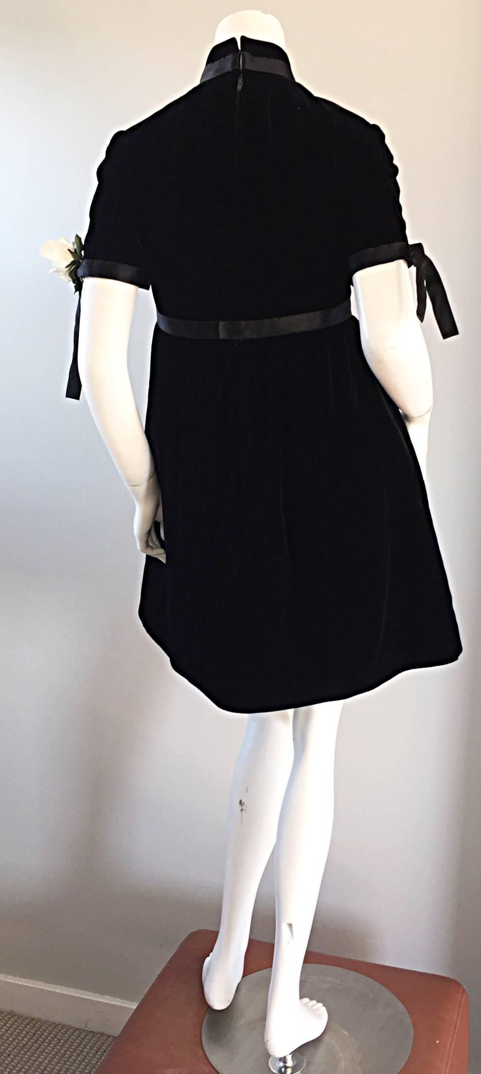 Wonderful 60s Geoffrey Beene black velvet trapeze dress, with white silk corsage at sleeve! Black silk ribbon detail at empire waist, at collar, and at each sleeve. Demi couture quality, with hand-sewn finishings. Built in interior support at waist.