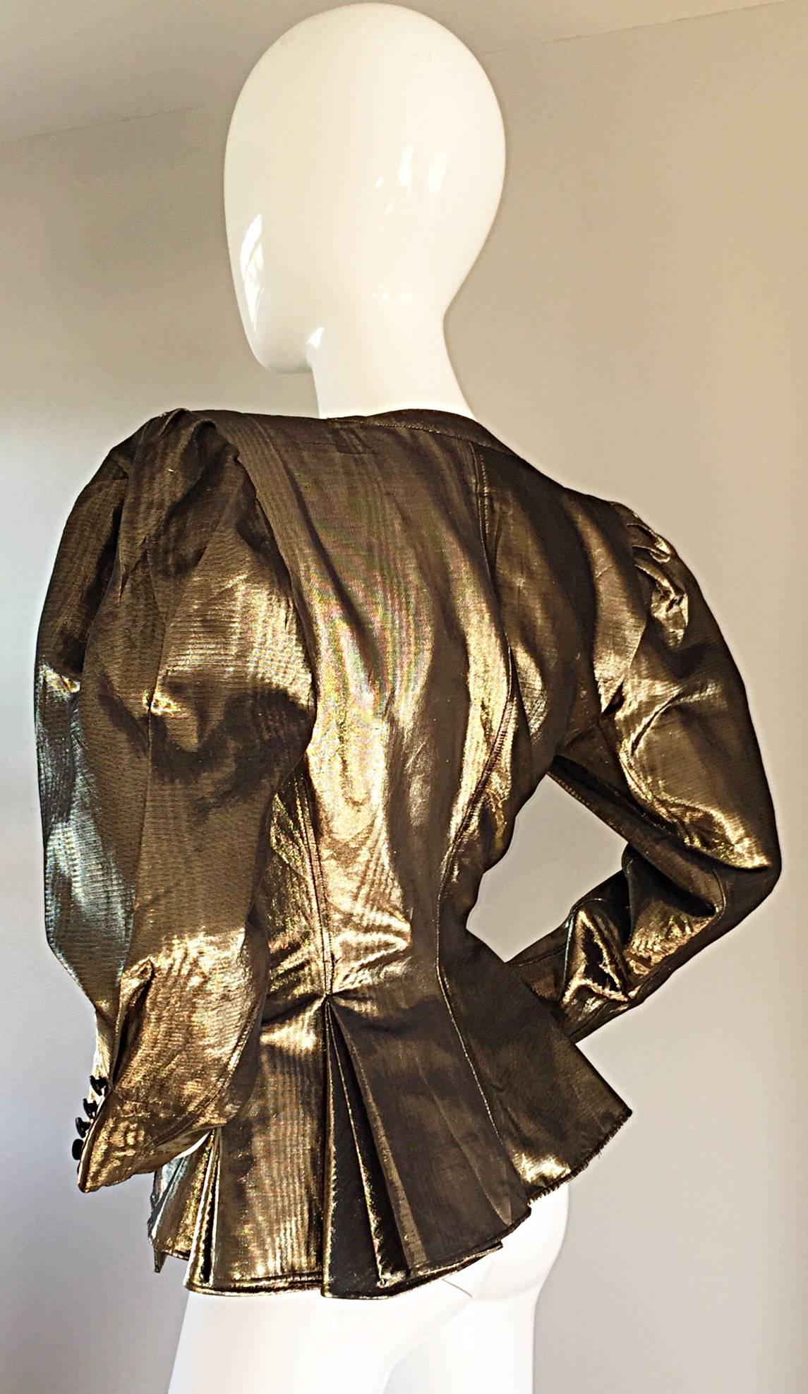 Gorgeous vintage EMANUEL UNGARO gold metallic avant garde jacket / blazer! Gold metallic silk, with dramatic sleeves, and tapered cuffs. Buttons up the waist, with exterior and interior buttons at bust. Can be left open, or buttoned all the way up.