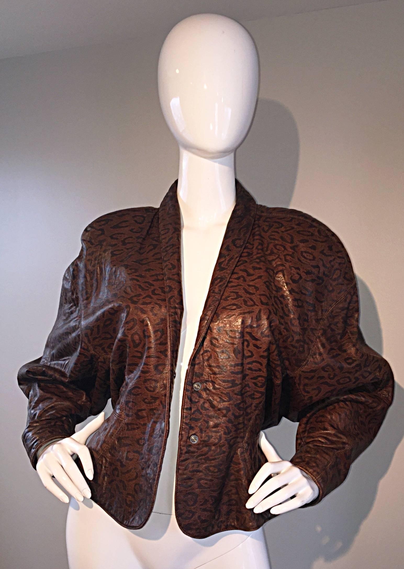 Amazing vintage North Beach Leather, by Michael Hoban leopard / cheetah print brown and black leather jacket! Full dolman sleeves, with slim cuffs, and a figure flattering wasp waist. Shawl collar, that looks great flipped up. Two snaps up the front