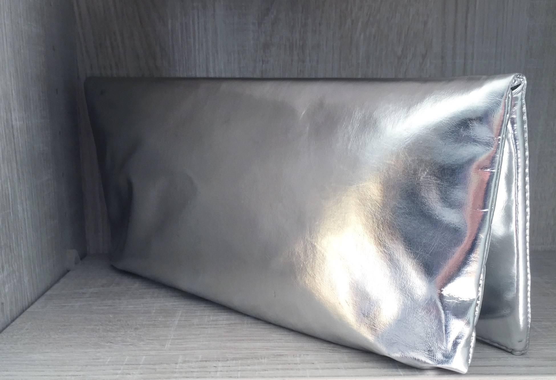 Amazing vintage Thierry Mugler silver metallic fold-over oversized envelope clutch! New deadstock vintage (never worn). Avant Garde style, with Mugler signature on front silver metal frame, with a silver metal star on the middle. Great size, that