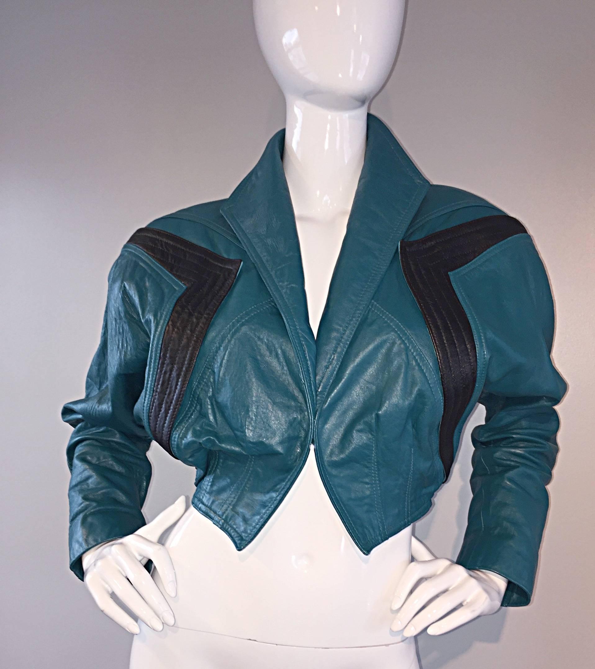 Amazing avant garde vintage 80s Kelli Kouri teal blue cropped leather bolero jacket! Amazing style, with panels of black at shoulders. Great construction, with a collar that can be down, or popped up, and sleeves ruched up for a more fashion-forward