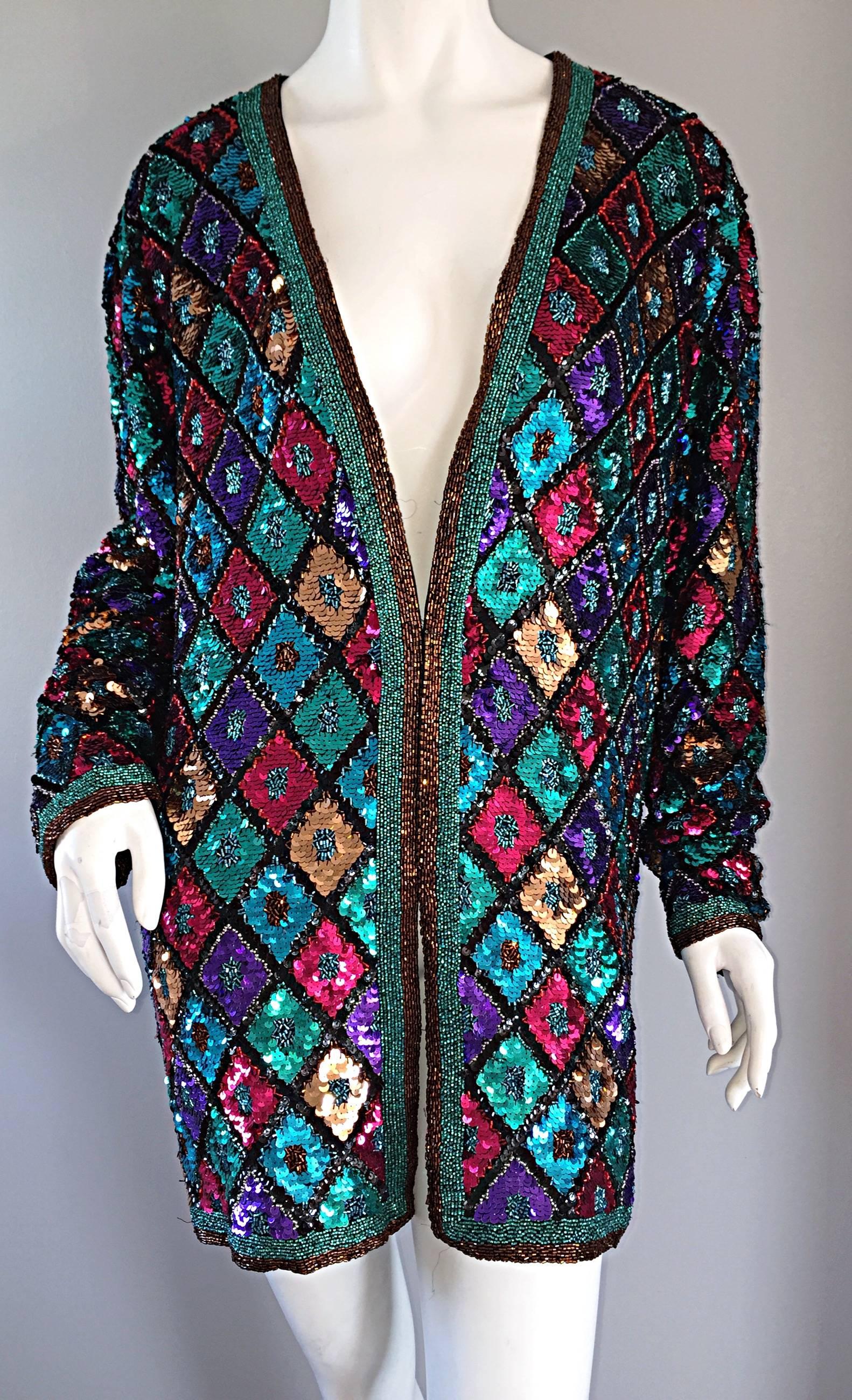 
Beautiful vintage Oleg Cassini fully sequined and beaded slouchy silk jacket / cardigan! The possibilities are endless with this beauty! Hot Pink, fuchsia, blue, teal, black, and gold sequins throughout, with teal and bronze seed beads trimming