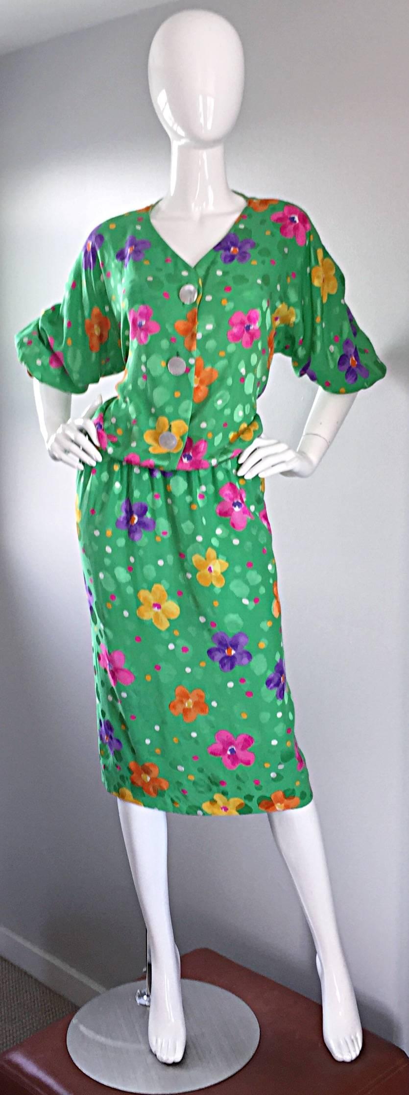 Beautiful vintage AKRIS dress! Wonderful kelly green color, with colorful flowers printed throughout. Pearlized disc buttons up the bodice, with hidden snap closure at neck. Sleeves can be left down, or rolled up. 100% Silk. In great condition. Made