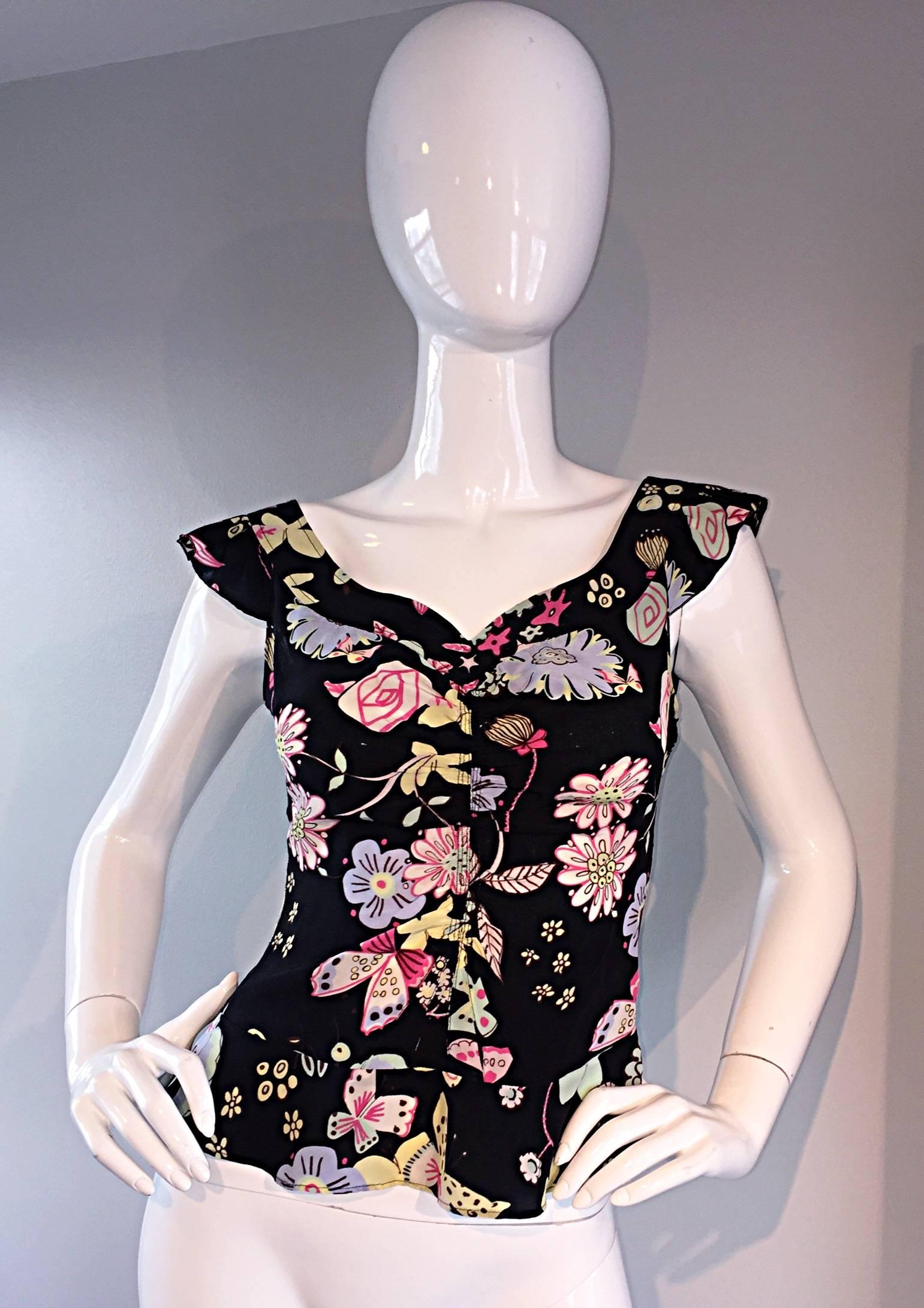 Beautiful early 1990s Moschino Cheap & Chic blouse! Black backdrop, with an array of pastel colored flowers, roses, and butterflies. Feminine fit, that looks great with shorts, jeans, trousers, or a skirt. Sweetheart neckline. In great condition.