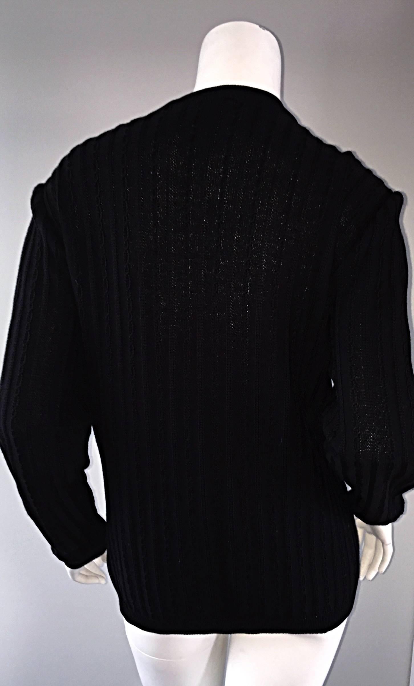 The perfect black cardigan! This vintage CELINE jumper is so smart, and perfect for everyday! Slouchy, but fitted, as the wool is so fine, it just drapes the body effortlessly. Jet black color, with gold horsebit chains at each pocket on the waist.