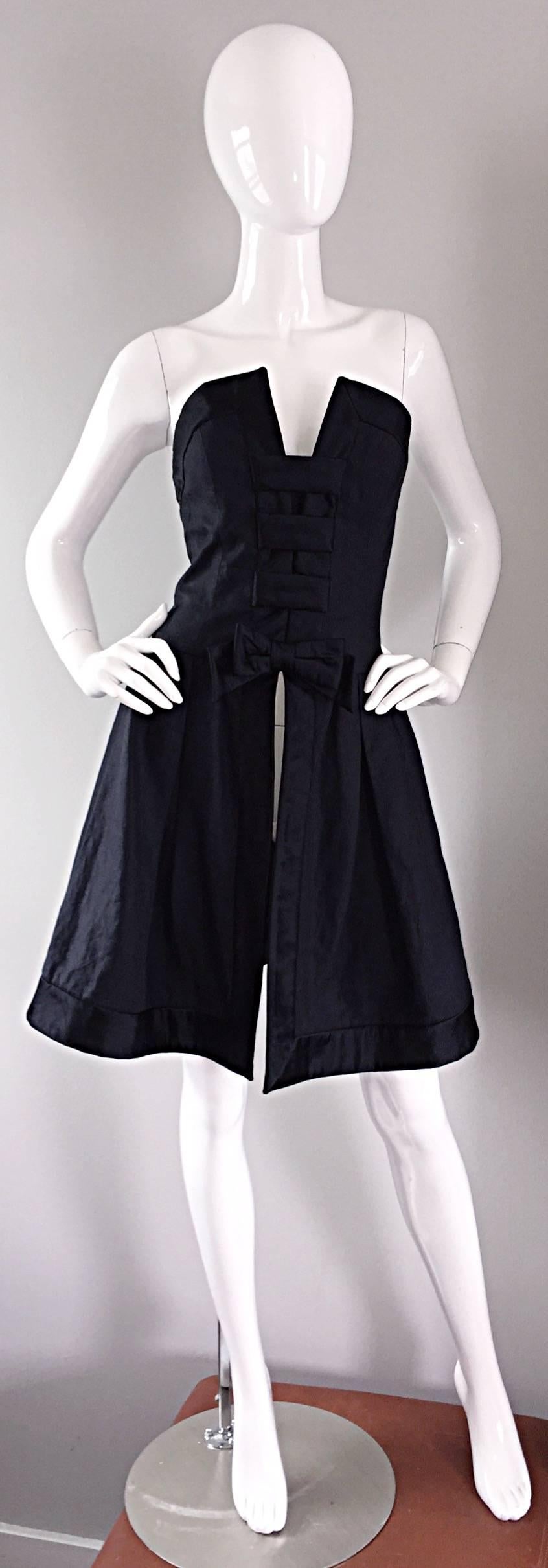 Chic vintage RENA LANGE black silk ' Avant Garde ' bow overdress! Dramatic bust line, with black silk bow adorned at waist. Cut-outs at back. Looks amazing on! Great with over simple black dress, or perfect with slacks. This is truly an AMAZING