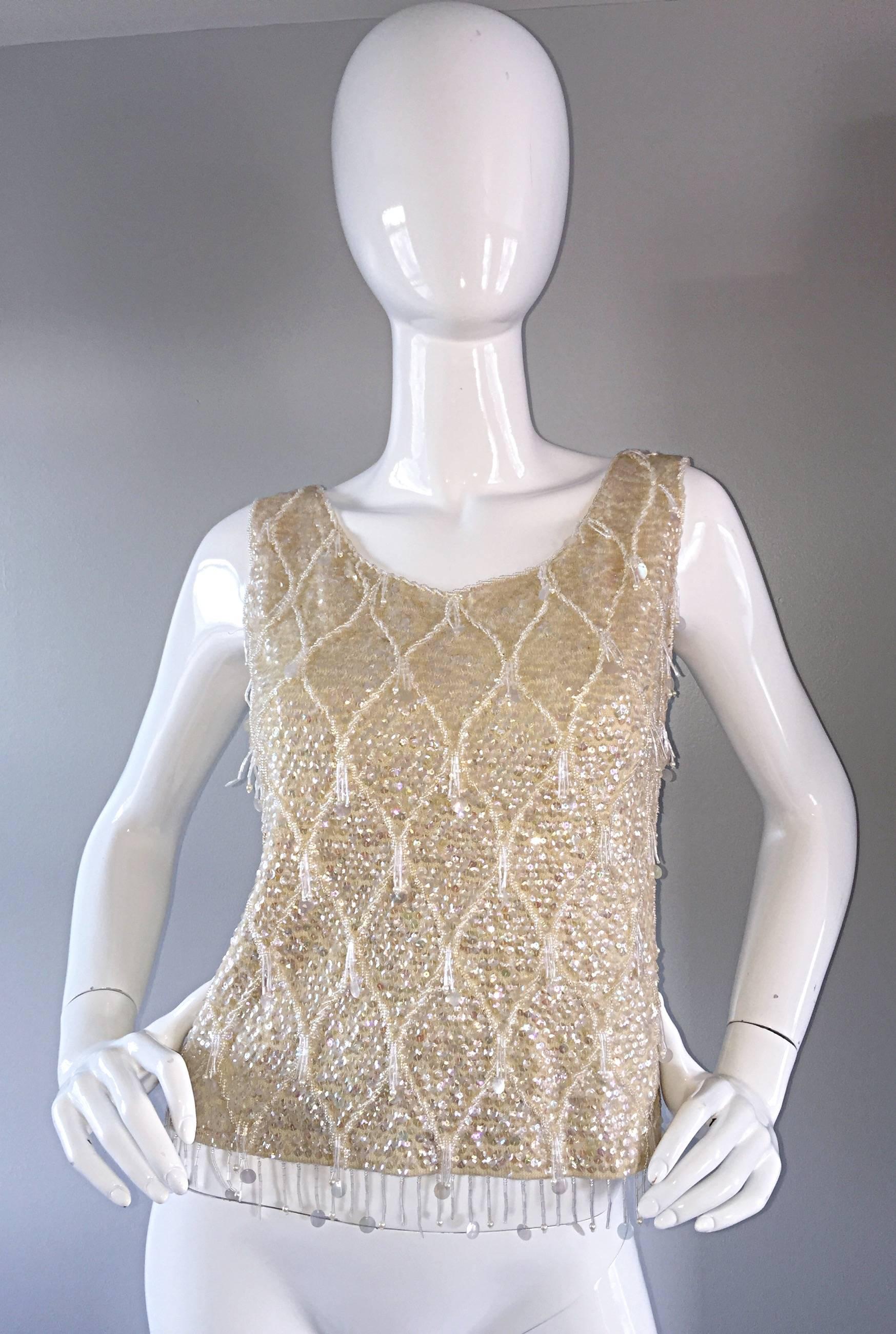 Amazing late 50s / early 60s ivory  wool beaded (and sequined) sleeveless sweater! Thousands of hand-sewn sequins throughout, with dangling beads at each crest. So much detail, and expert craftsmanship...not your typical vintage beaded jumper! Full