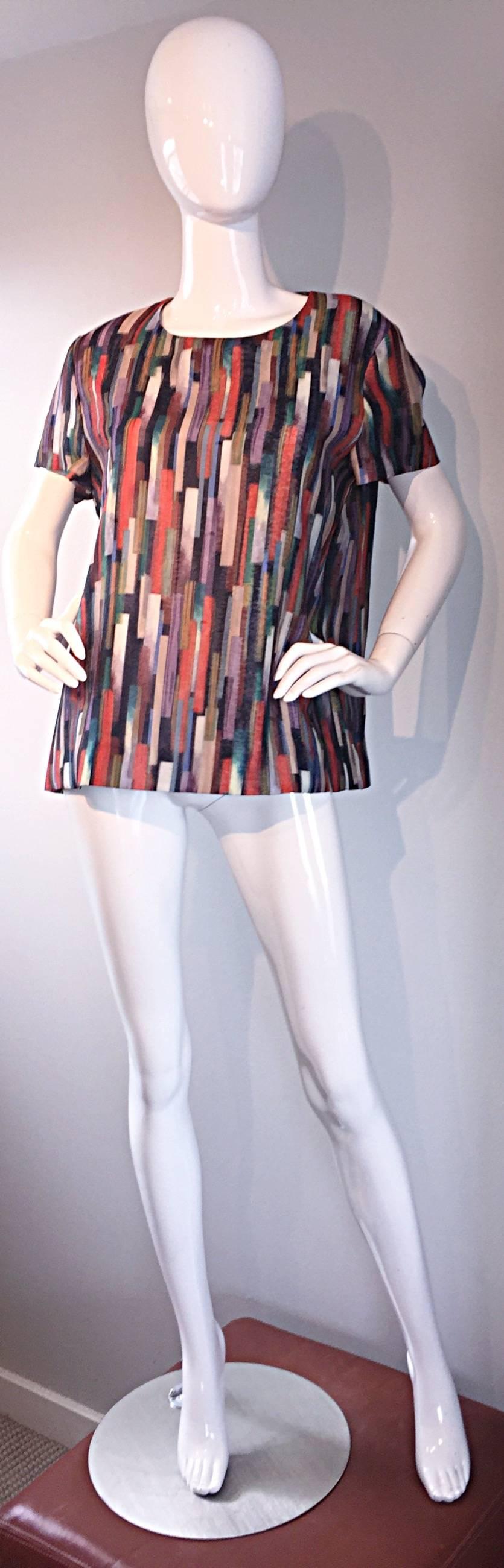 Beautiful GERARD DAREL abstract colorful swing top! Wonderful shape, that looks great on all shapes and sizes. Fitted bodice, with a flared hem. Flattering abstract print on double layered silk. Metal zipper at back neck. Looks great with jeans,