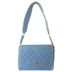 Vintage CHANEL denim bag with golden cc closure and vertical stitches. 