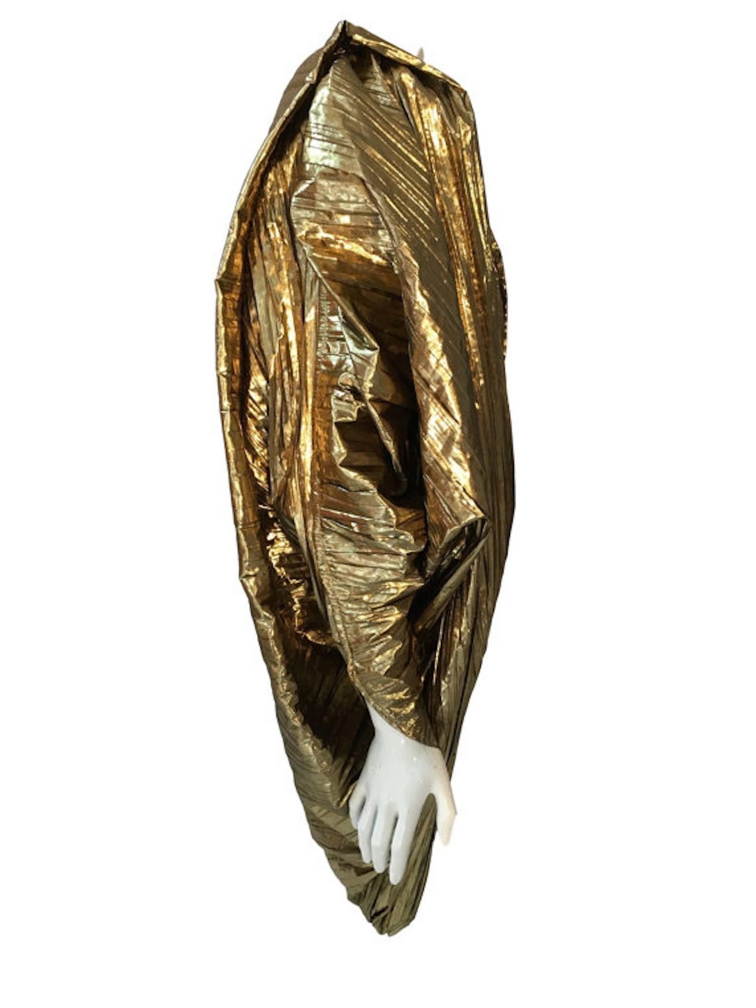 A fabulous and outrageous vintage metallic evening jacket. Made pleated from gold metallic material, has fitted cuffs and cocoon shaped body. Has shoulder pads. Labelled 