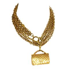 Vintage CHANEL golden double chain long necklace with classic 2.55 bag charm.