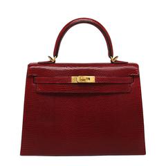 Hermès - Sac Kelly 25 cm en lézard rouge avec accessoires dorés 